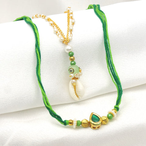 Cowrie shell emerald bhaiya bhabhi rakhi set with pearl chain and green CZ by Joyrias