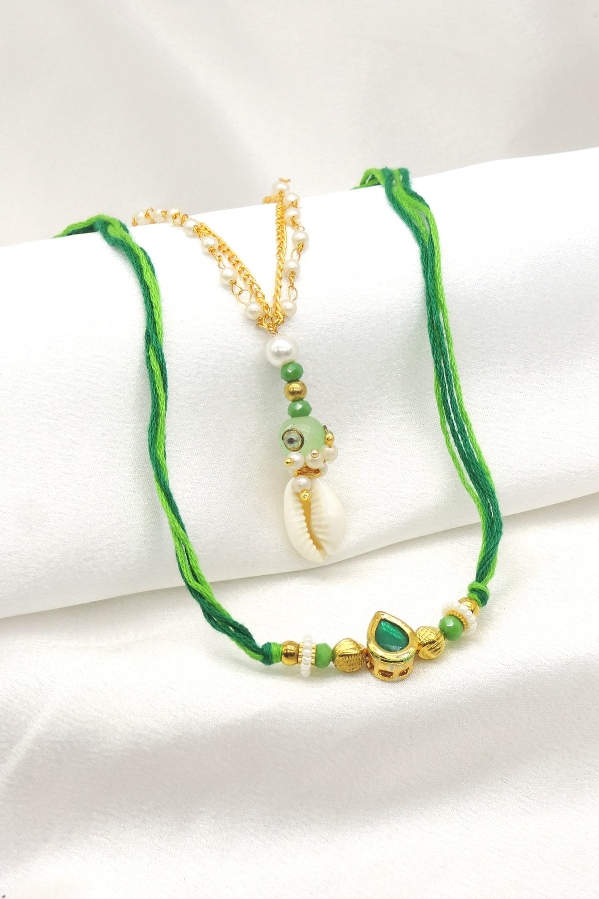 Cowrie shell emerald bhaiya bhabhi rakhi set with pearl chain and green CZ by Joyrias