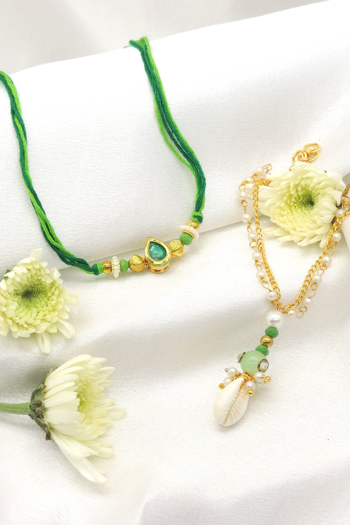 Emerald teardrop cowrie pearl bhaiya bhabhi rakhi set by Joyrias