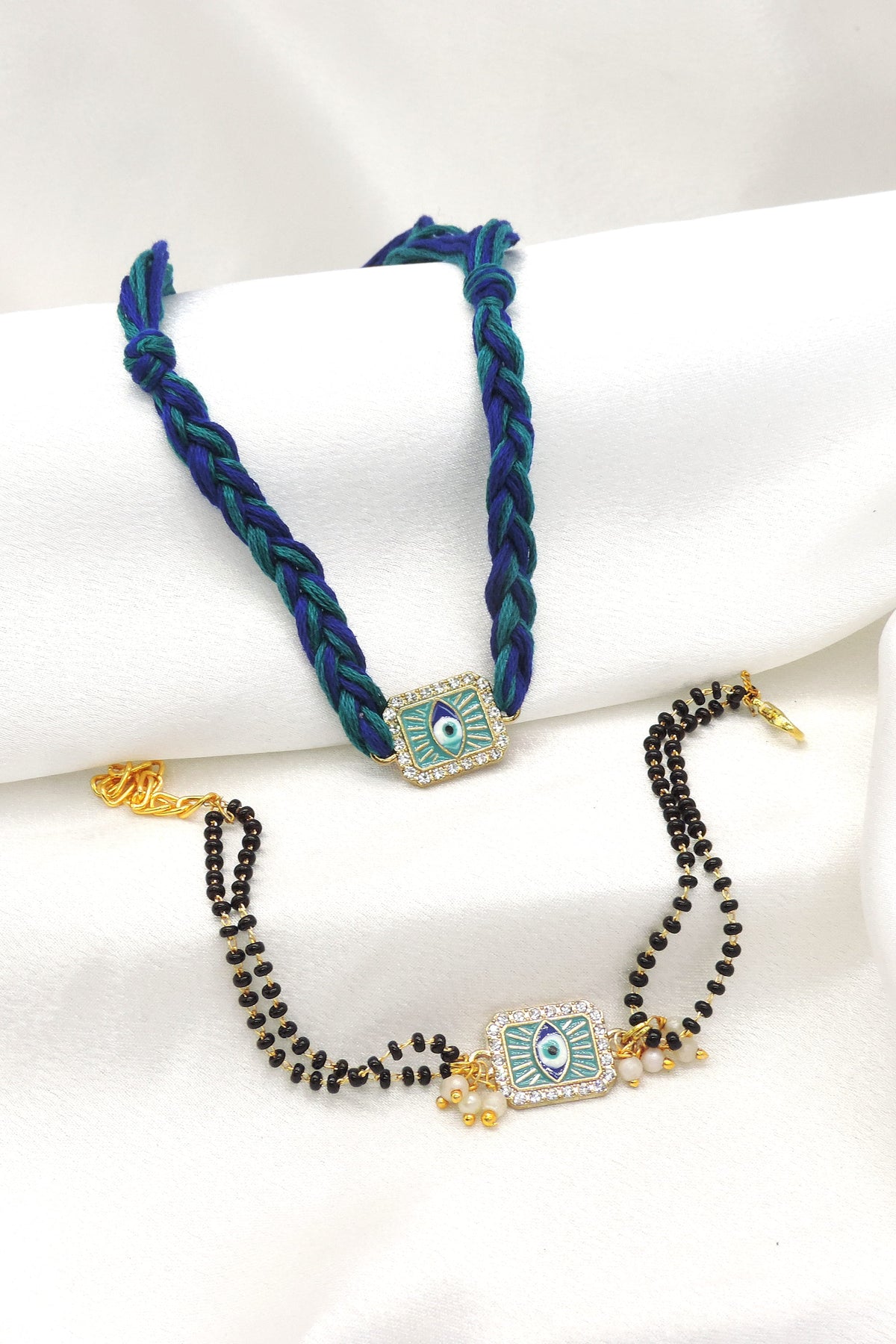 Evil eye bhaiya bhabhi rakhi set with CZ border and black bead chain by Joyrias