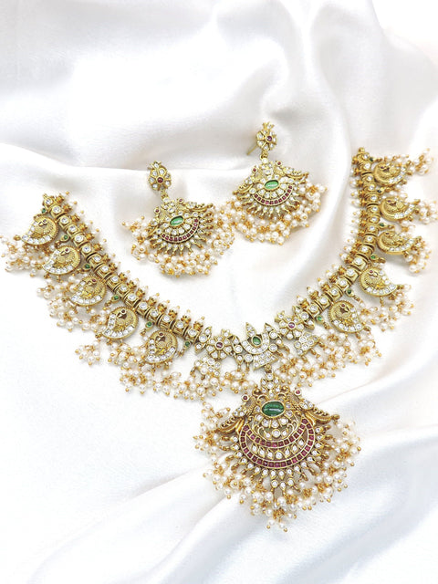 Temple peacock multicolor Kundan necklace set with green and ruby stones, pearl detailing and matching earrings by joyrias