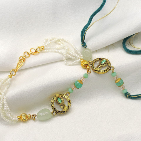 Peacock feather mint pearl bhaiya bhabhi rakhi set by Joyrias