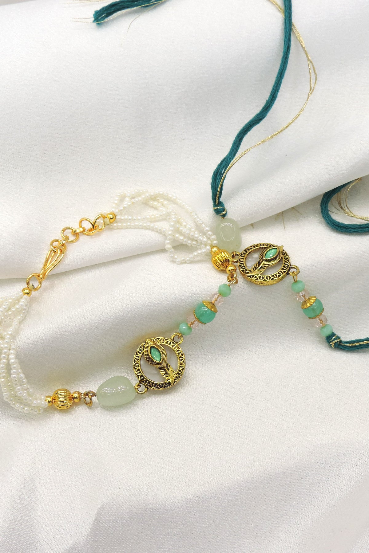 Peacock feather mint pearl bhaiya bhabhi rakhi set by Joyrias