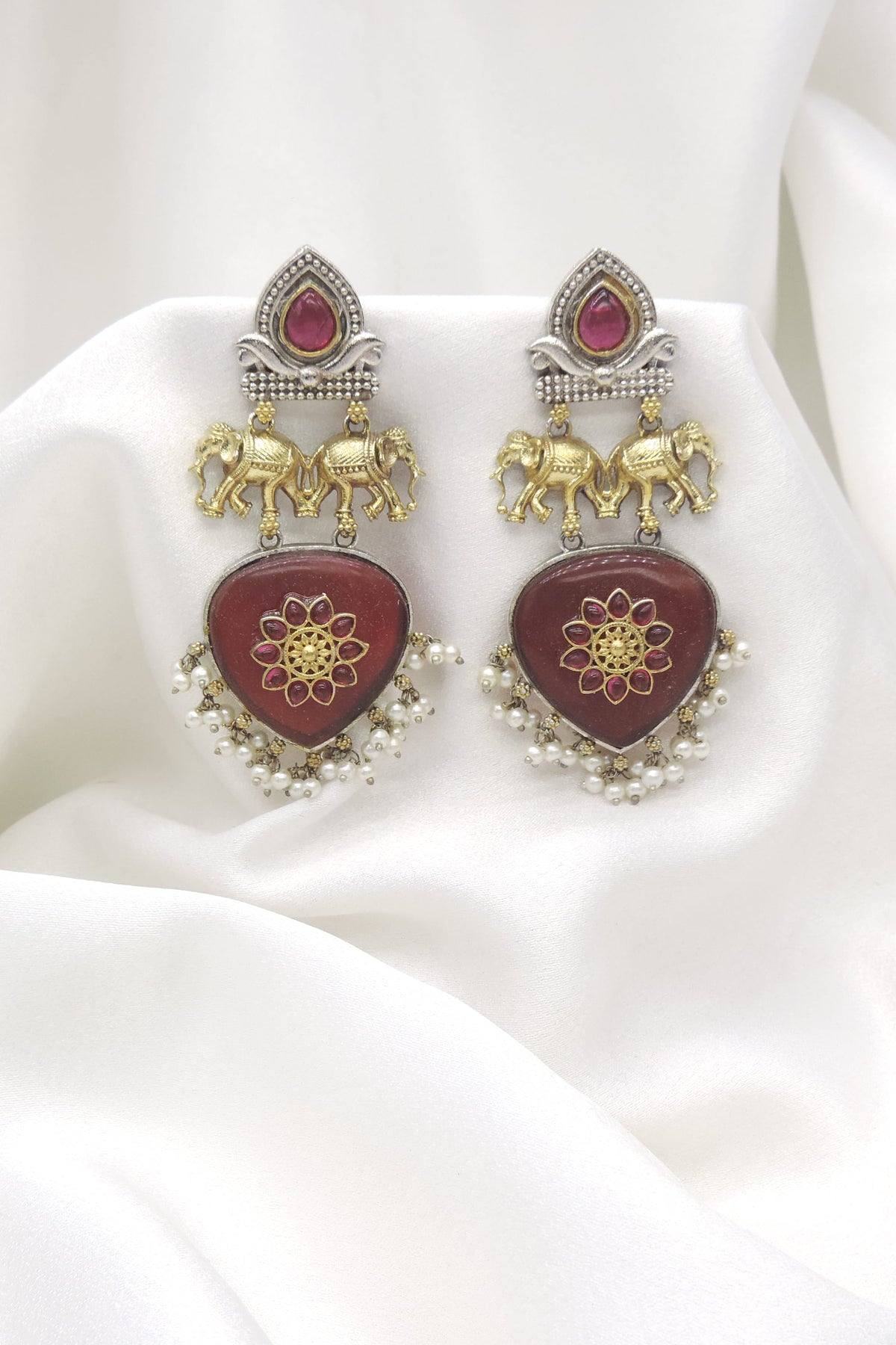 Oxidized dual-tone elephant maroon pearl drop earrings with gold-toned and silver detailing by joyrias