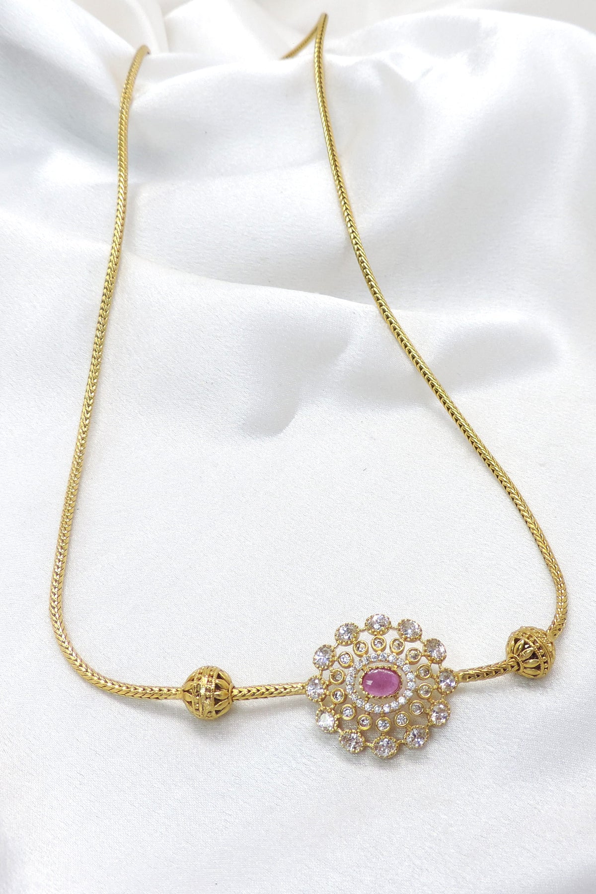 Pink CZ AD necklace with circular pendant and gold-tone detailing by joyrias