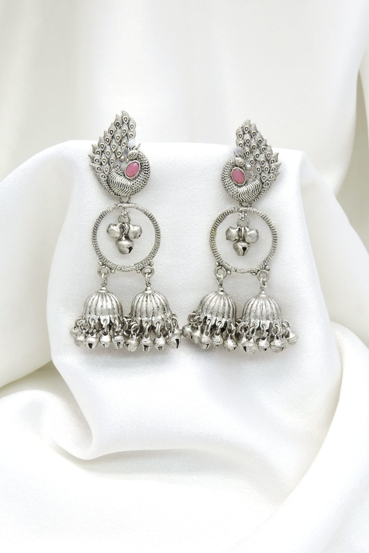 Oxidized silver peacock pink stone double jhumka earrings with intricate feather detailing by joyrias