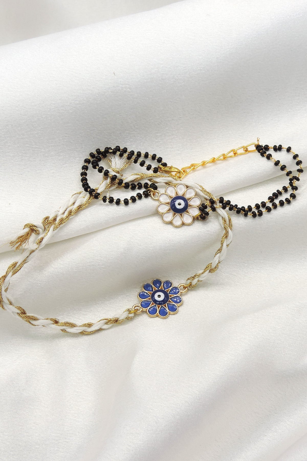 Evil eye floral enamel bhaiya bhabhi rakhi set by Joyrias