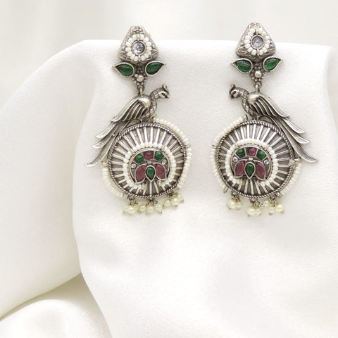 Oxidized silver peacock green pink jhumka earrings with intricate feather detailing by joyrias