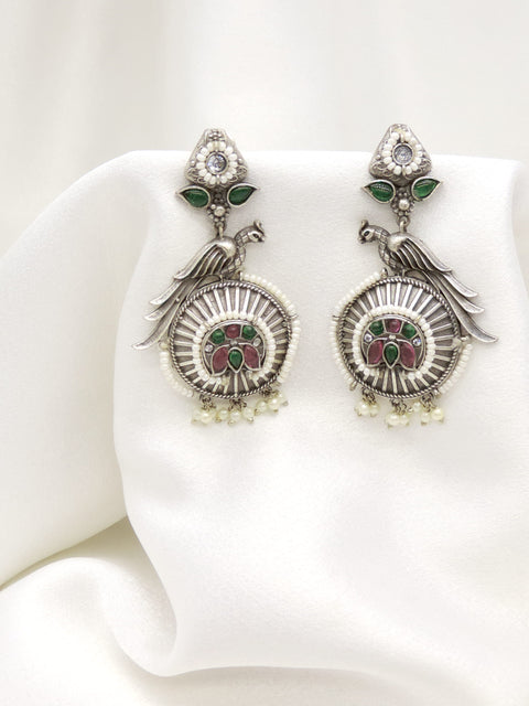 Oxidized silver peacock green pink jhumka earrings with intricate feather detailing by joyrias