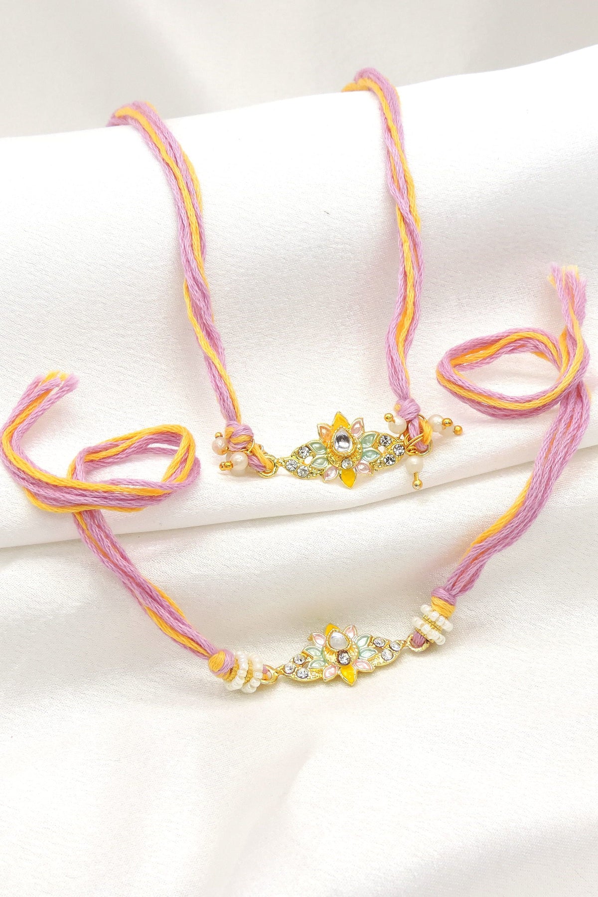 Pastel floral kundan CZ bhaiya bhabhi rakhi set by Joyrias