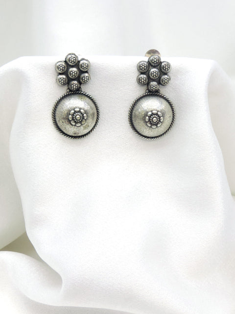 Oxidized silver floral circle drop earrings with intricate dotted detailing by joyrias