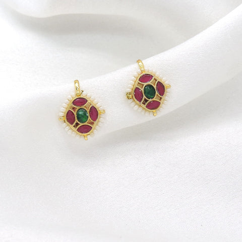 Gold-toned green maroon kundan drop earrings with white bead detailing by joyrias