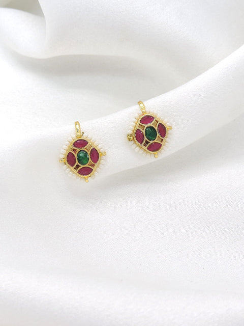 Gold-toned green maroon kundan drop earrings with white bead detailing by joyrias