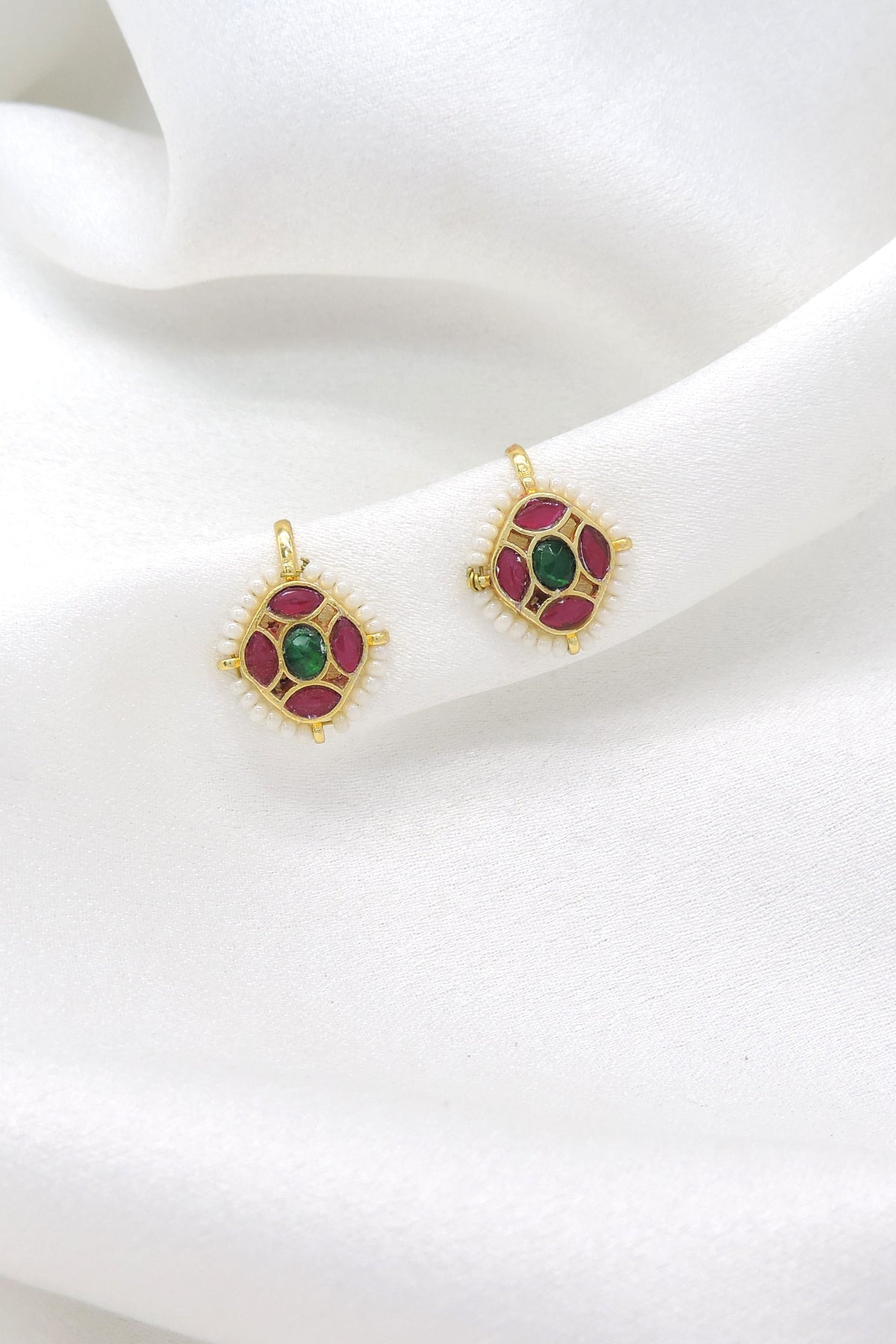 Gold-toned green maroon kundan drop earrings with white bead detailing by joyrias