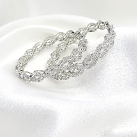 Elegant silver-toned wave AD bangle set with intricate detailing by joyrias