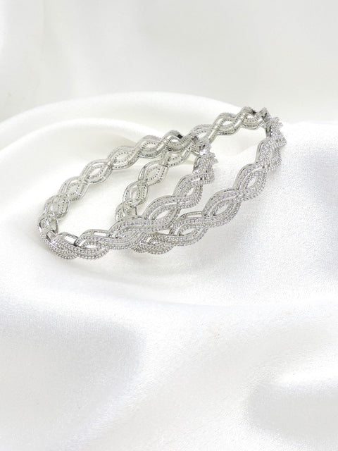 Elegant silver-toned wave AD bangle set with intricate detailing by joyrias