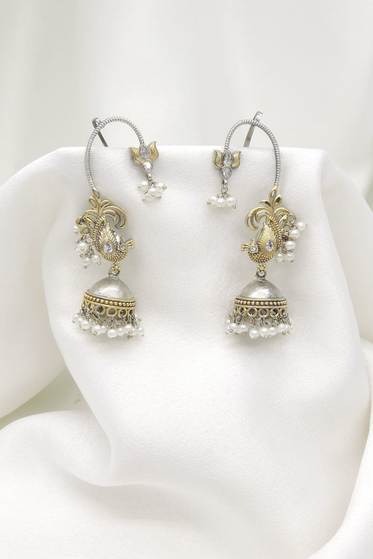 Oxidized dual-tone paisley ear cuff earrings with gold-toned detailing and pearl accents by joyrias