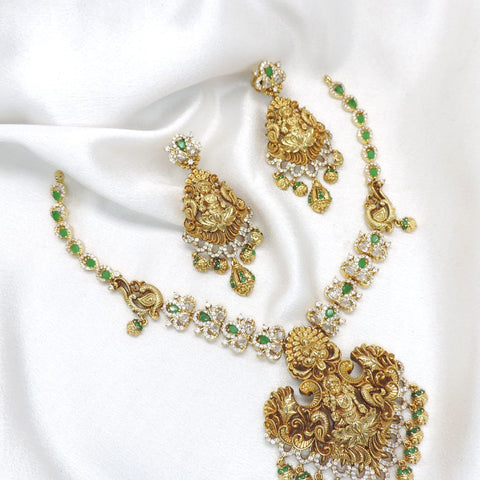 Royal green kundan necklace with matching earrings and ornate gold tone detailing by joyrias