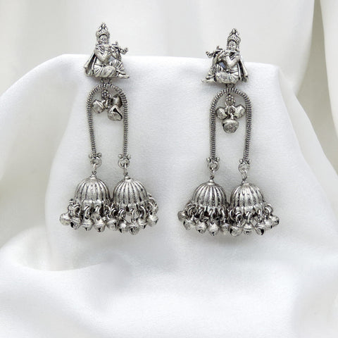 Oxidized silver Krishna flute double jhumka earrings with intricate traditional detailing by joyrias