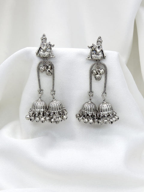 Oxidized silver Krishna flute double jhumka earrings with intricate traditional detailing by joyrias