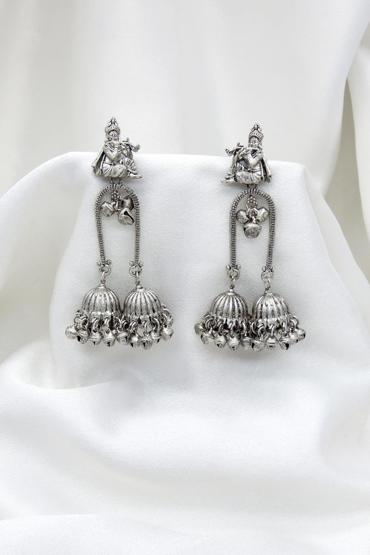 Oxidized silver Krishna flute double jhumka earrings with intricate traditional detailing by joyrias