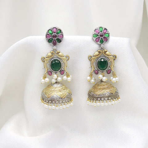 Oxidized dual-tone green stone floral jhumka earrings with gold-toned detailing and pearl fringe by joyrias