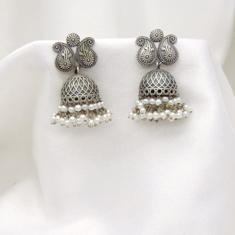 Oxidized silver floral paisley jhumka earrings with intricate dome and pearl detailing by joyrias