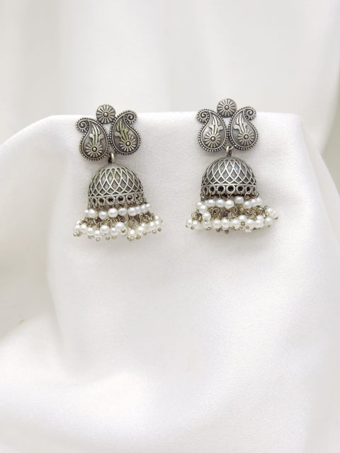 Oxidized silver floral paisley jhumka earrings with intricate dome and pearl detailing by joyrias