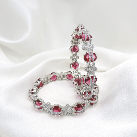 Silver-toned pink stone AD bangle set with intricate floral detailing by joyrias