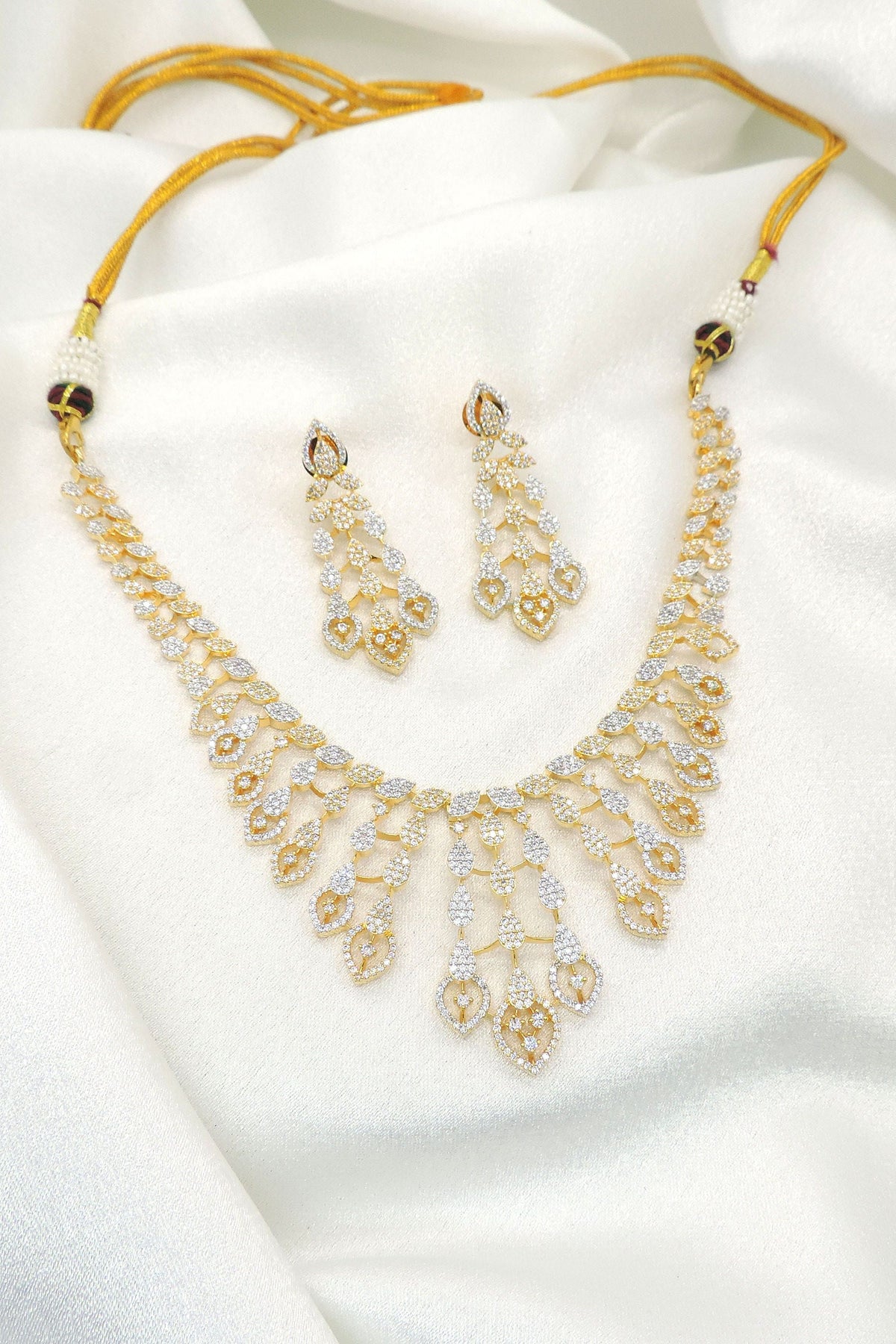 Gold plated layered teardrop necklace set with sparkling stones and matching earrings