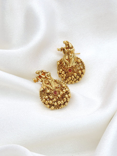 Gold-toned temple jhumka earrings with intricate traditional detailing by joyrias