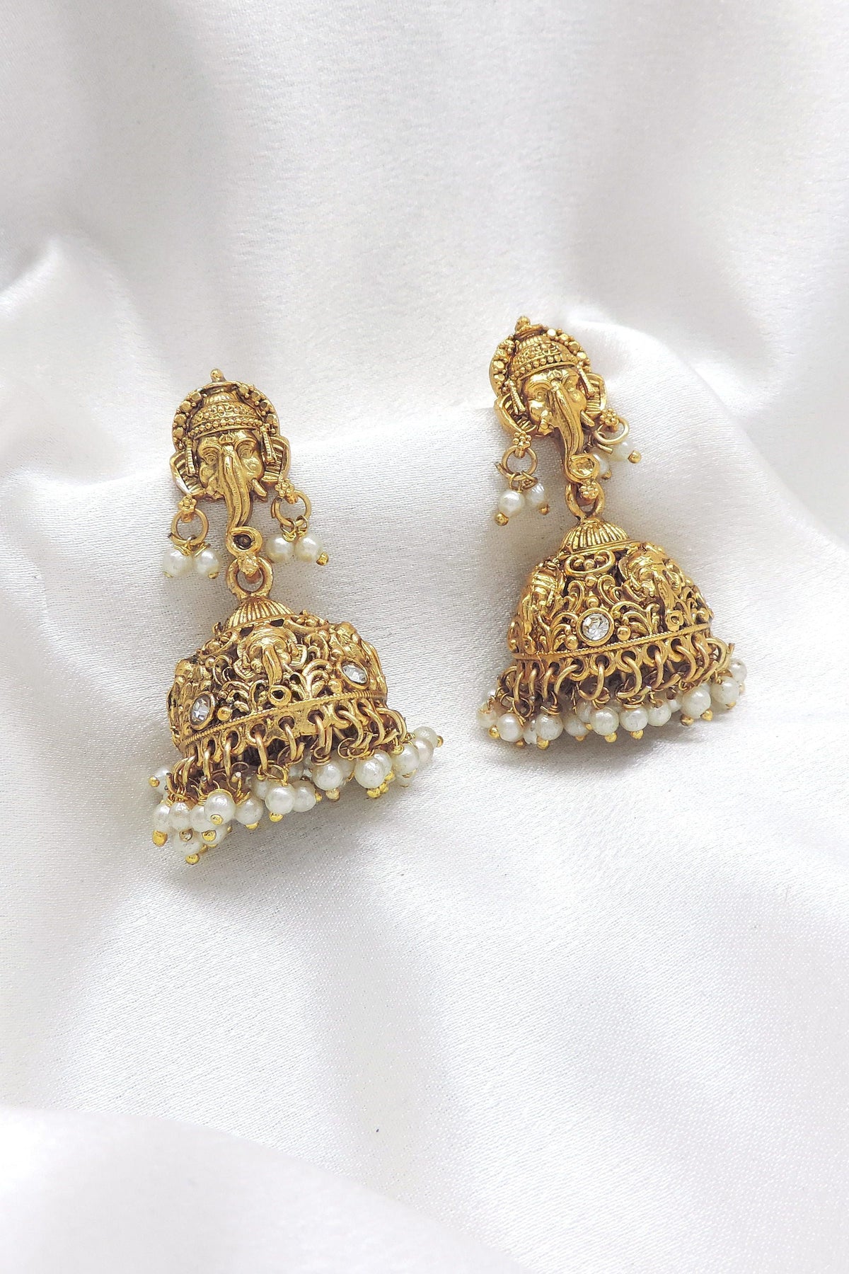 Temple gold-toned Ganesha jhumka earrings with pearl detailing by joyrias