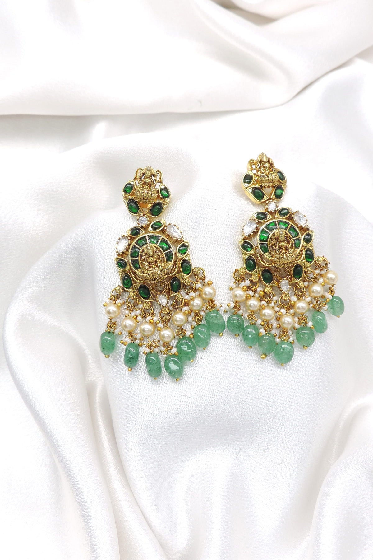 Temple gold-toned Lakshmi necklace set with green stones and pearl drops by joyrias