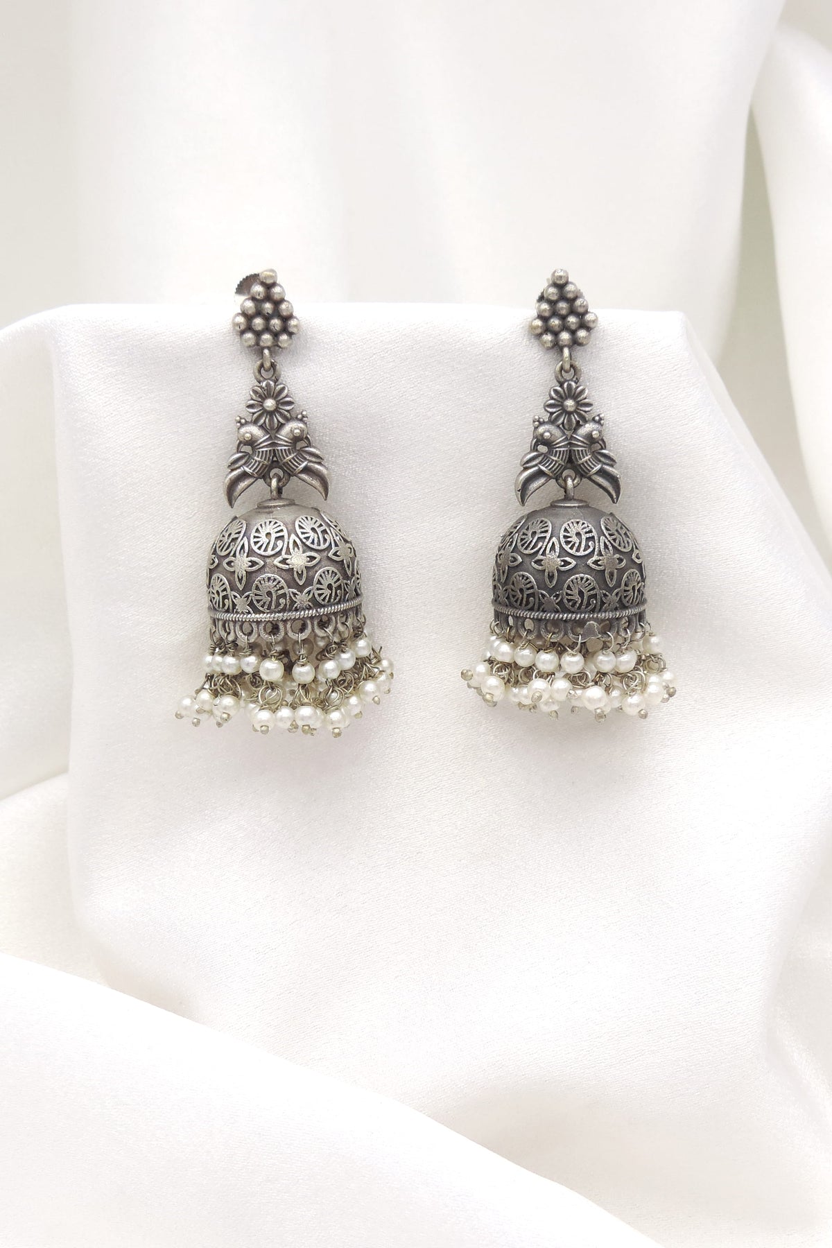 Oxidized silver floral jhumka earrings with intricate dome detailing and pearl fringe by joyrias