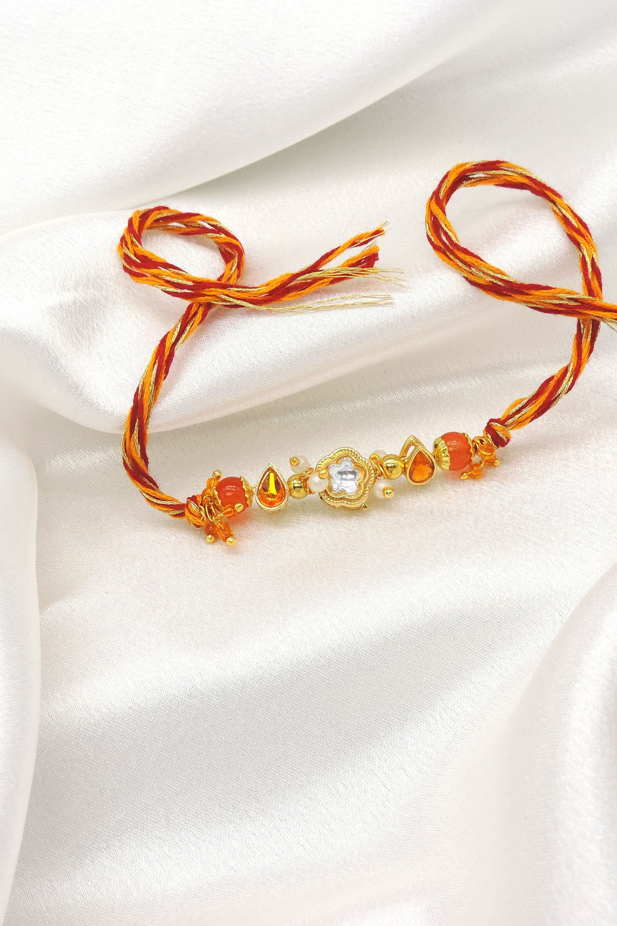 Designer Kundan Rakhi with Orange Crystal Beads