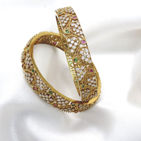 Kundan ruby and green bangle set with gold-tone detailing by joyrias