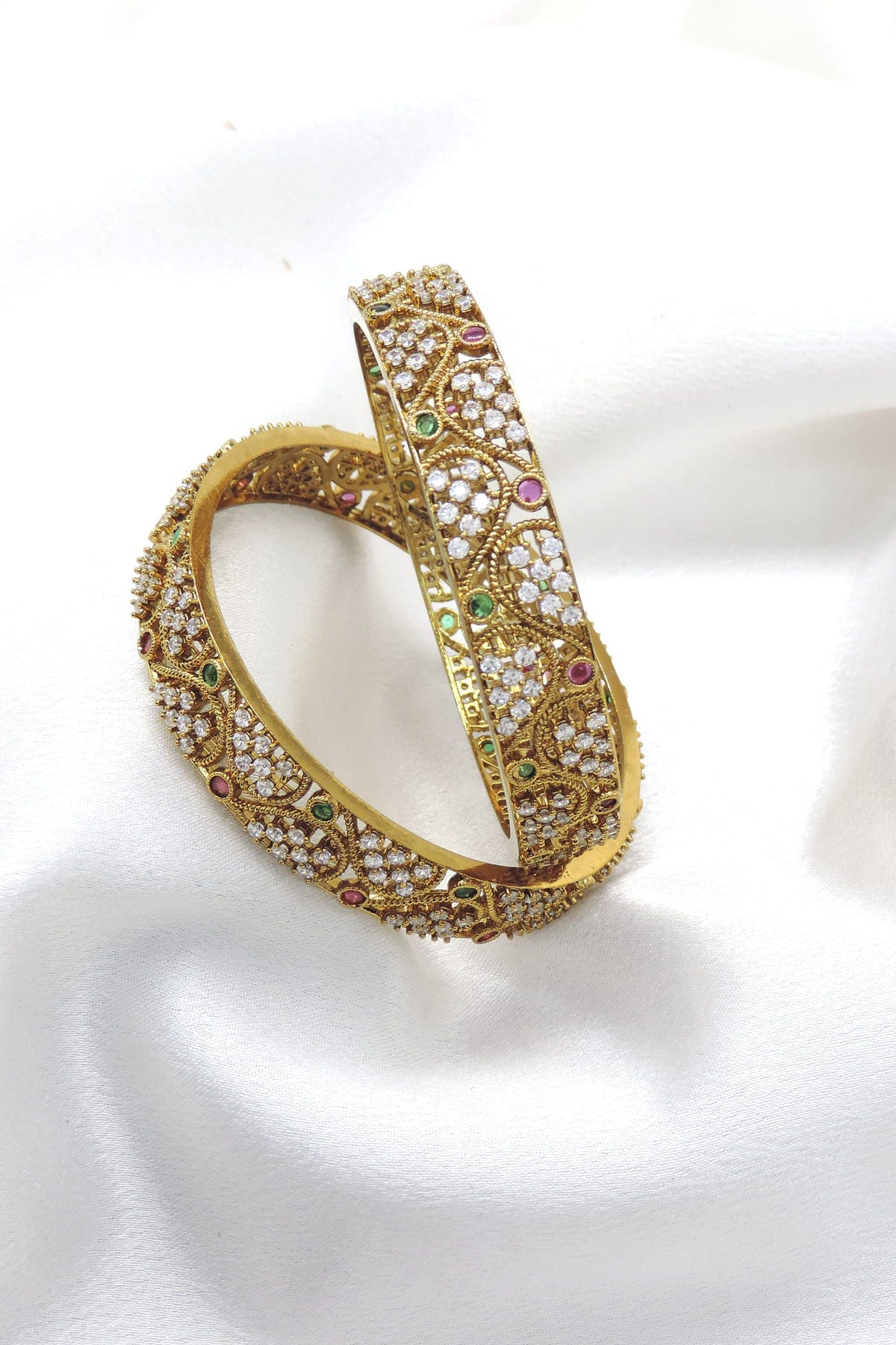 Kundan ruby and green bangle set with gold-tone detailing by joyrias