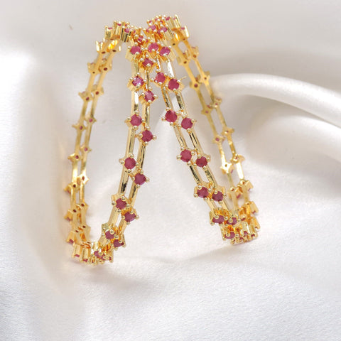 Rose ruby stone bangle set with gold-tone detailing by joyrias