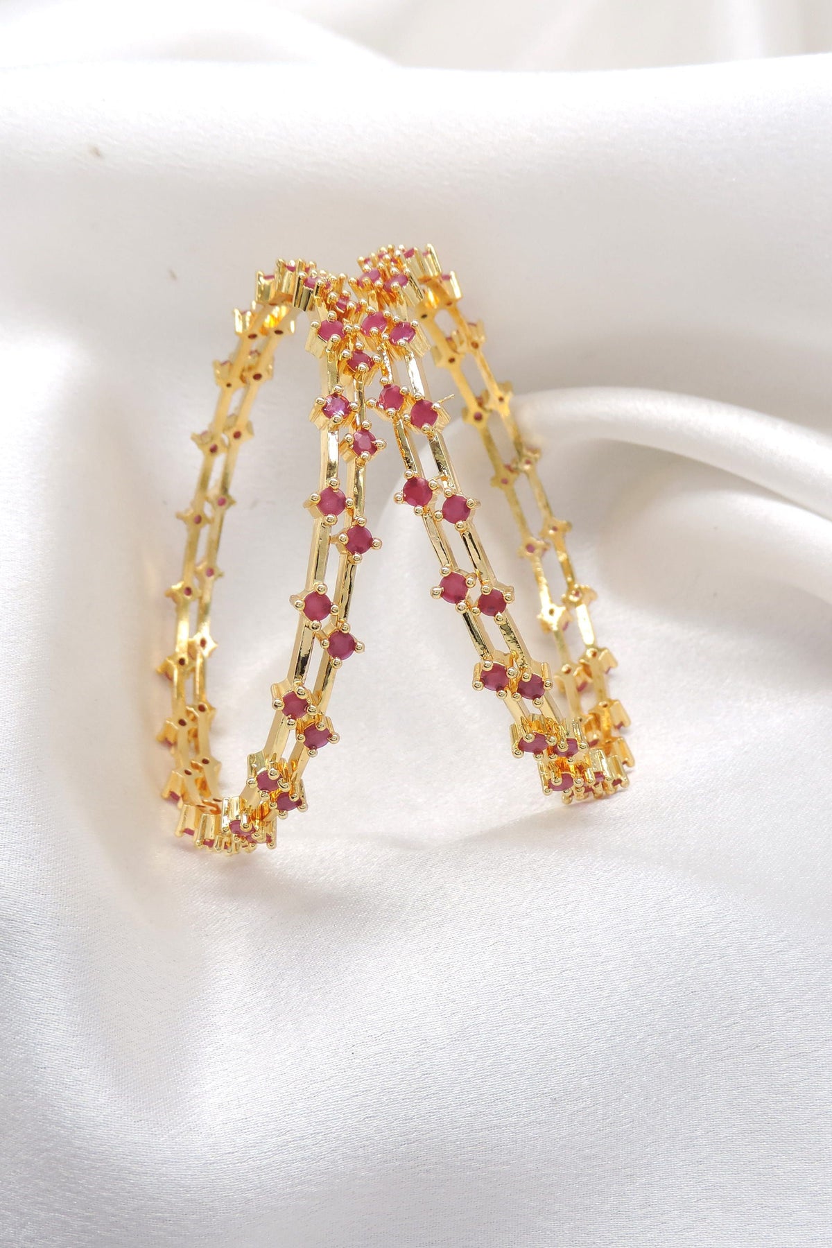 Rose ruby stone bangle set with gold-tone detailing by joyrias