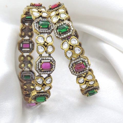 Opulent emerald ruby CZ AD bangle set with intricate stone accents by joyrias