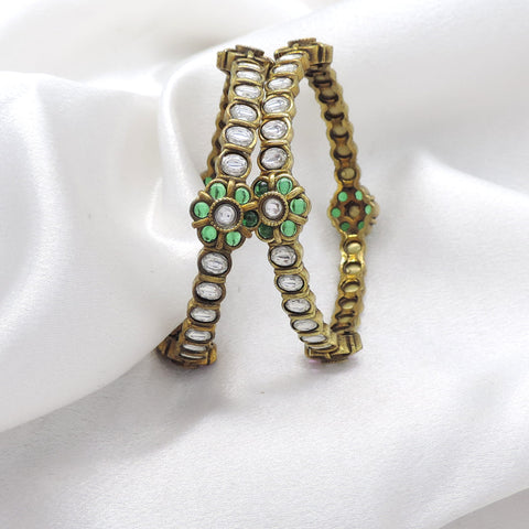 Emerald CZ AD bangle set with floral accents and intricate stonework by joyrias