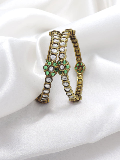Emerald CZ AD bangle set with floral accents and intricate stonework by joyrias