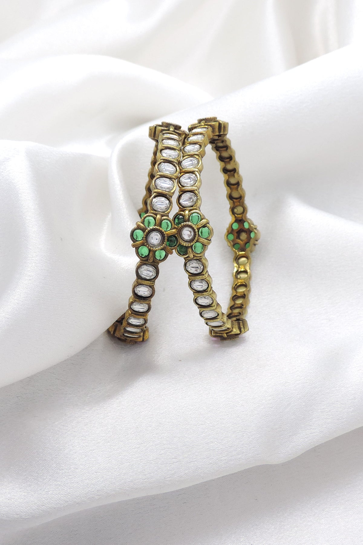Emerald CZ AD bangle set with floral accents and intricate stonework by joyrias