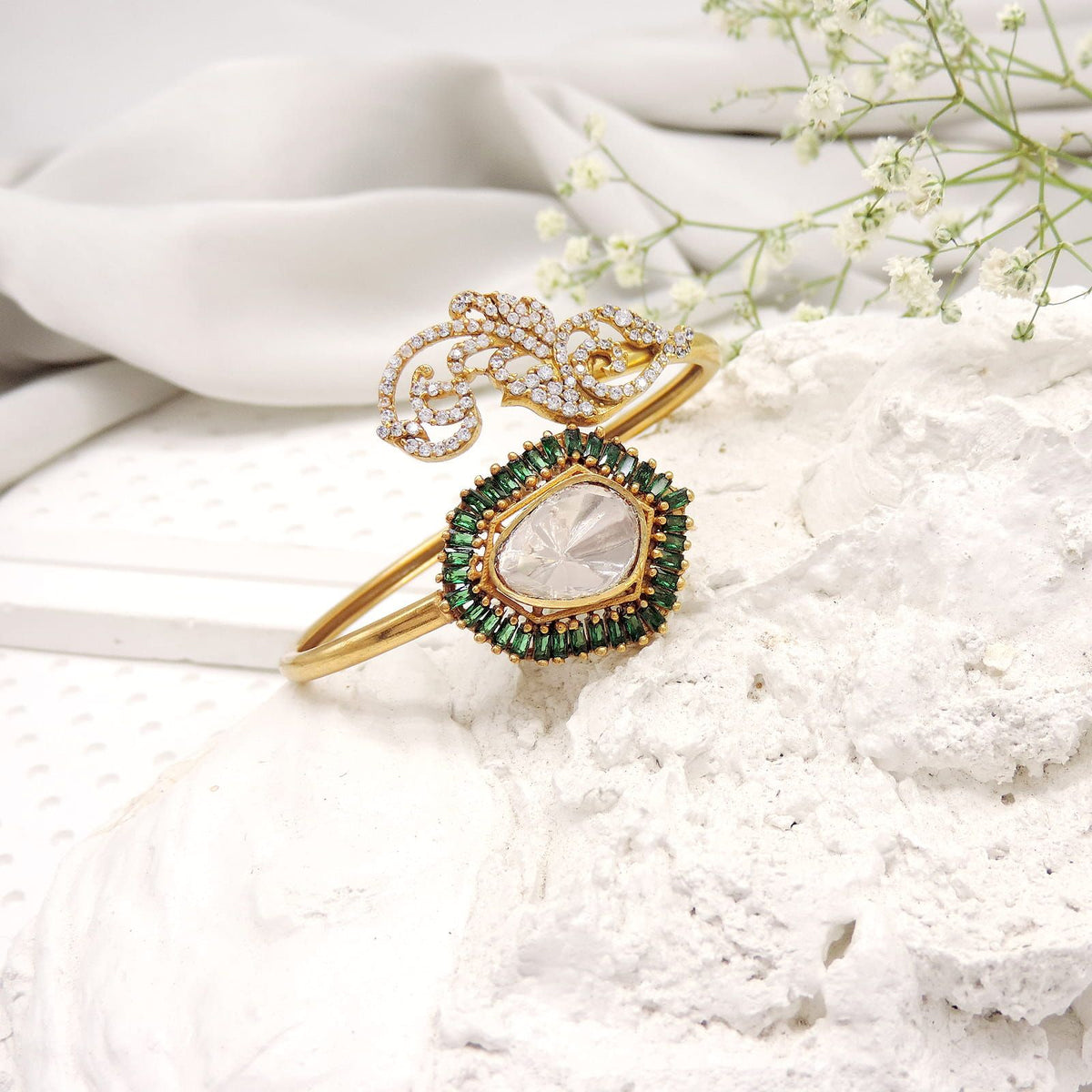 Adjustable open kada bracelet with kundan center and green accents