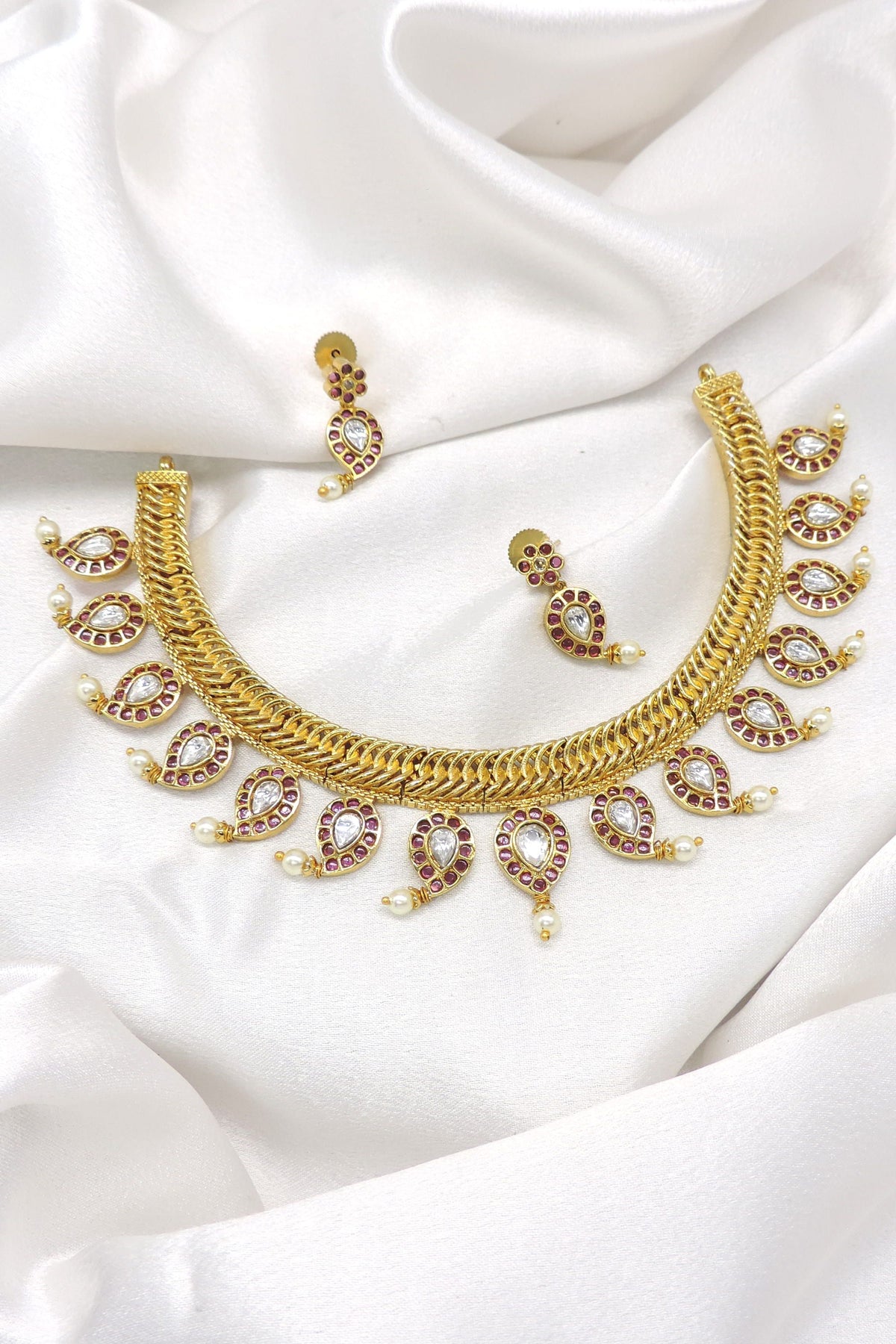 Maroon kundan pearl necklace with matching earrings and CZ AD detailing by joyrias