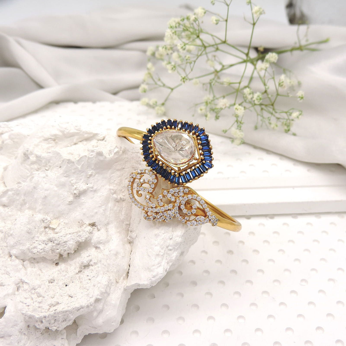 Open cuff bracelet with royal blue halo and kundan style center