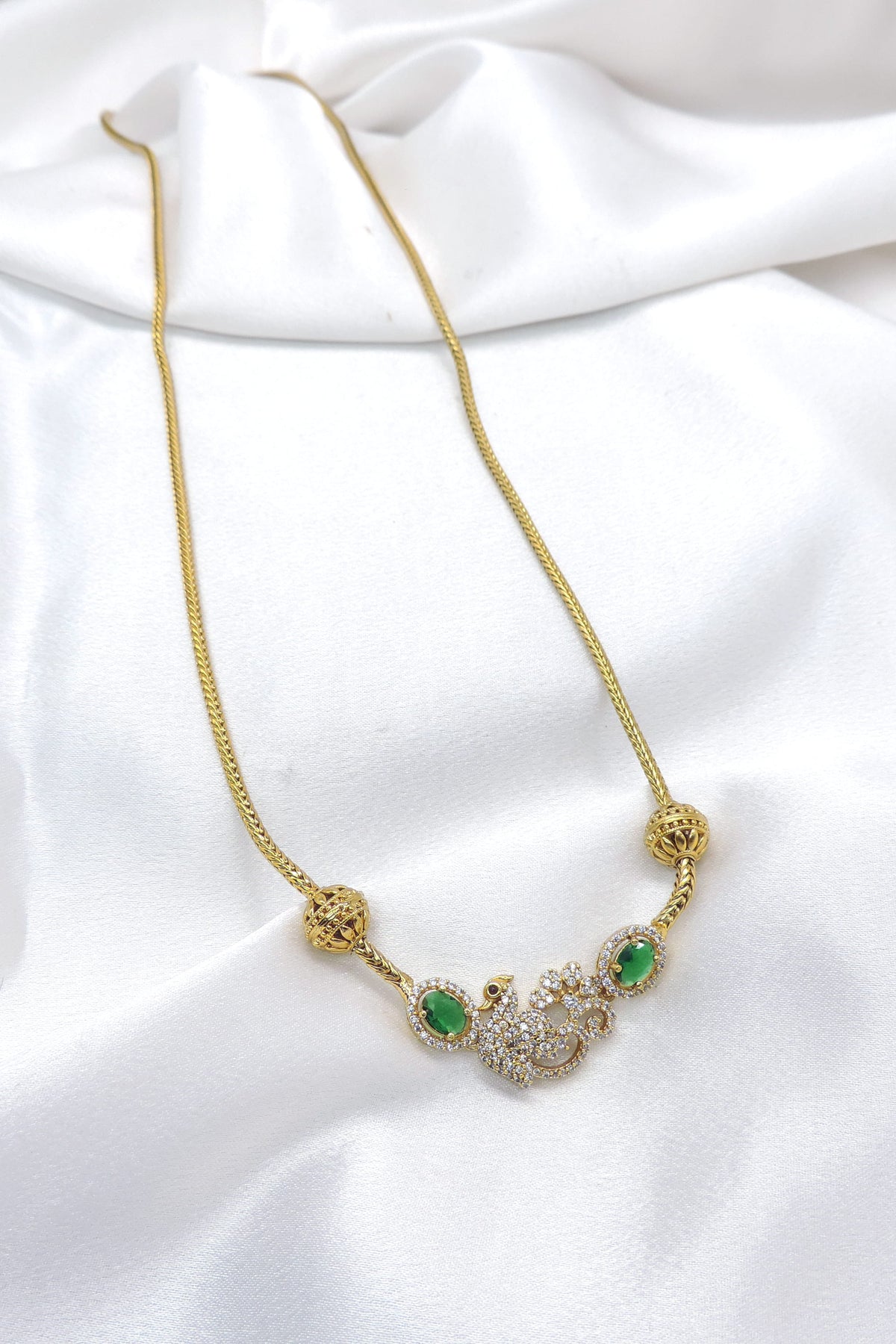 Gold chain necklace with peacock CZ AD pendant and emerald stones by joyrias