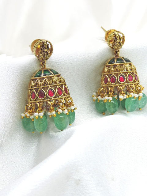 Antique Lakshmi temple jhumka earrings with red stones, green bead drops and pearl detailing by joyrias