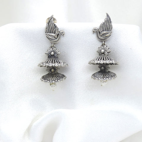 Oxidized silver bird motif double jhumka earrings with floral detailing and pearl drop by joyrias