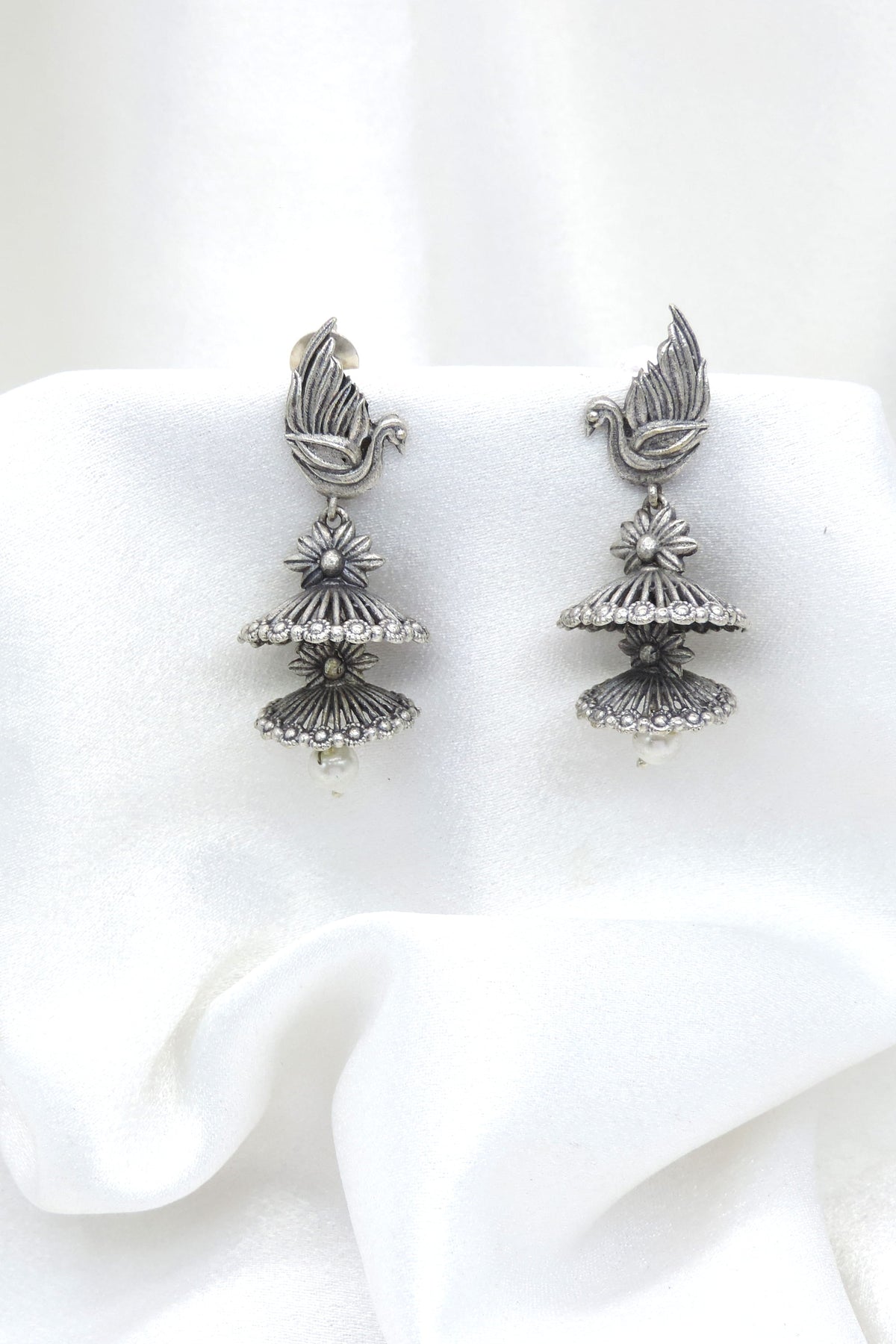 Oxidized silver bird motif double jhumka earrings with floral detailing and pearl drop by joyrias
